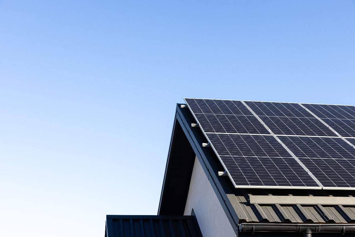 Black solar panels on top of a building