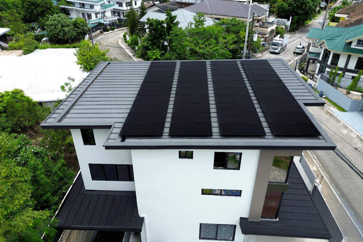 Modern house with insulated roof panels and solar panels viewed from above