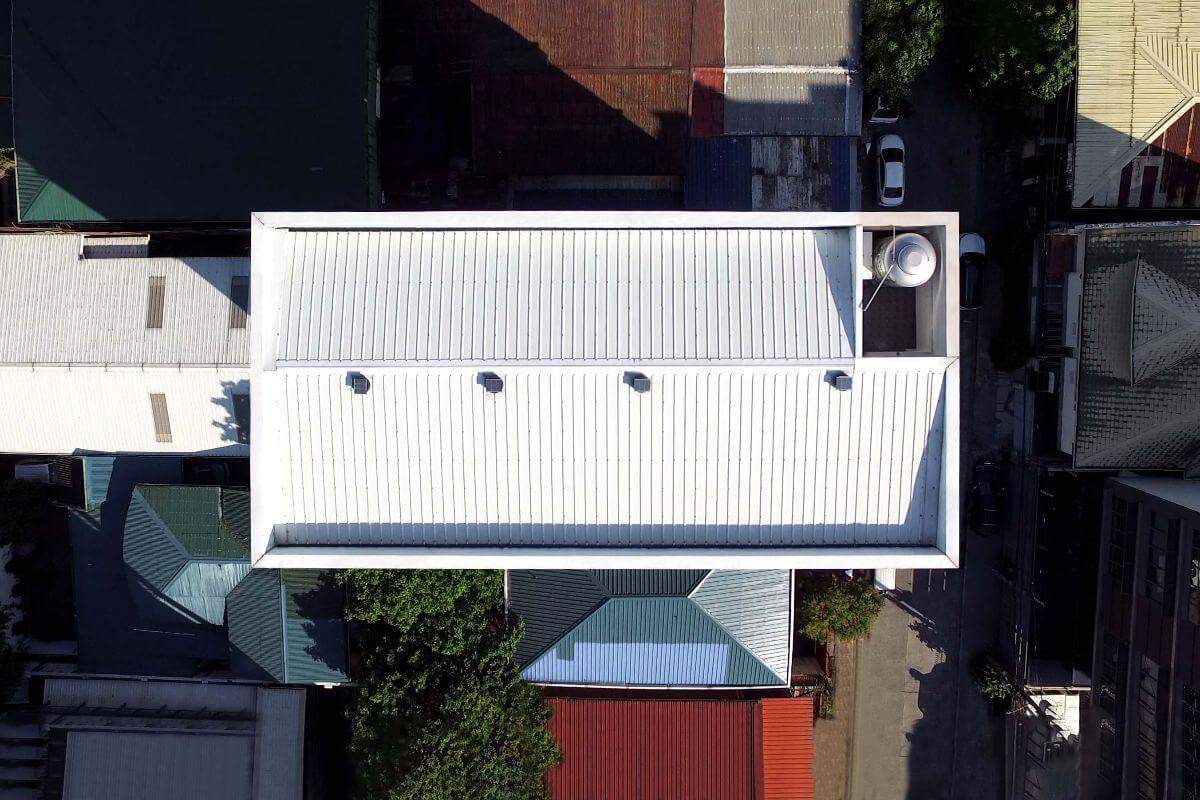 Aerial view of a white insulated roofing system on a residential or commercial building